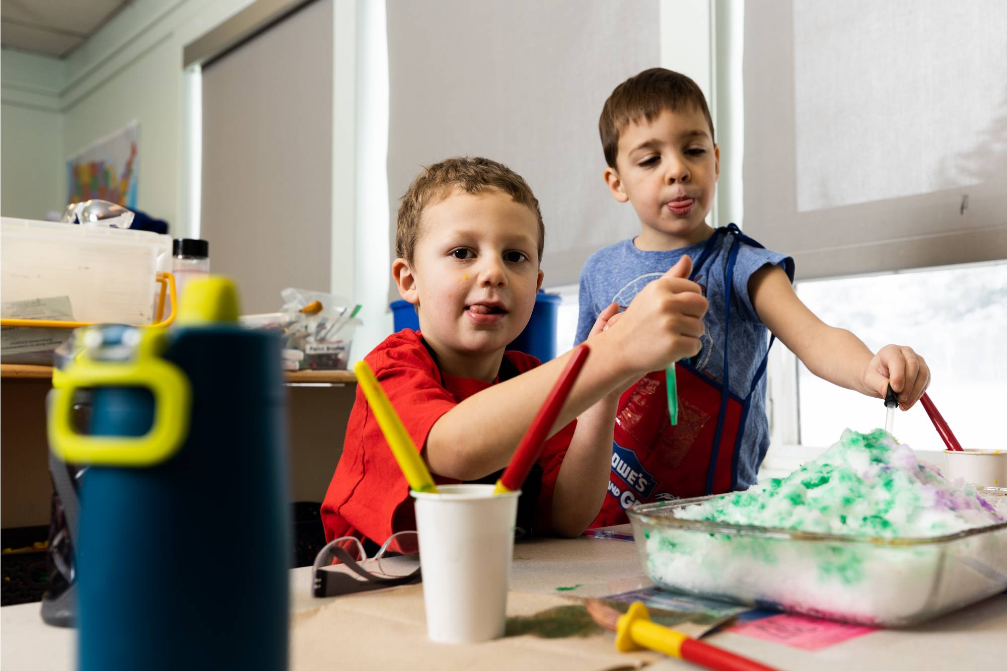 Kids sitting at the table doing science activities